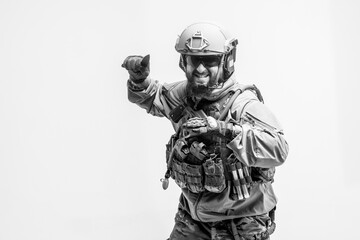 American soldier in military uniform attacks with a knife on a white background, a commando with knives