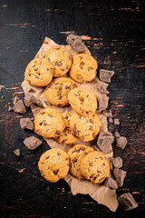 Cookies with pieces of milk chocolate on the table. 