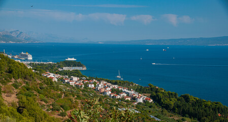 The view of a bay from a hill on the Mediterranean Sea in the town of split as boats and cruise ships enter the harbor