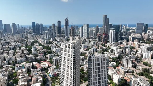 Aerial footage of a specially designed tower and houses in the city of Givatayim in Israel. In the background the skyline of Ramat Gan and Tel Aviv