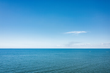 Obraz premium Horizon line, blue sky and blue sea. Drone view