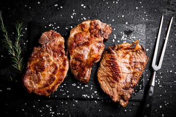 Grilled pork steak with a sprig of rosemary. 