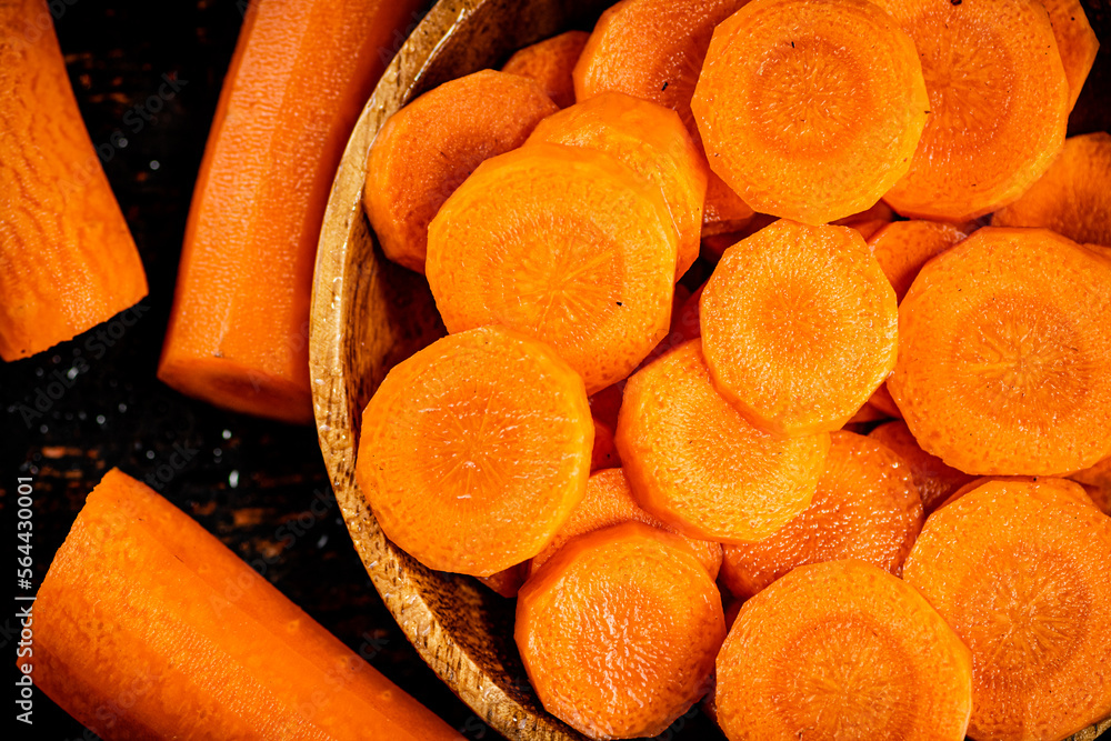 Wall mural Round pieces of fresh carrots on a plate. 