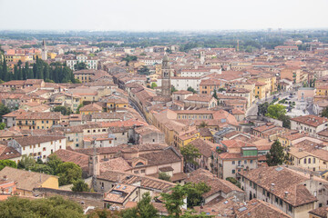 Fototapeta na wymiar Beautiful view of the panorama of Verona and the Lamberti tower on the banks of the Adige River in Verona, Italy