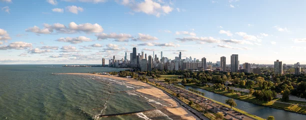  Beautiful aerial panorama view of the downtown Chicago skyline from above the water of Lake Michigan near Lake Shore Drive and South Lagoon in Lincoln Park  with blue sky and fluffy white clouds above © Joseph Kirsch
