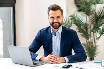 Photo of a handsome confident successful positive businessman, financial director, entrepreneur,...