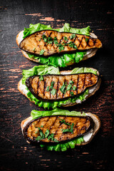 Sandwich with grilled fried eggplant and lettuce. 