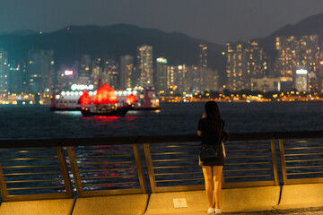 Fototapeta na wymiar woman standing in the city harbor at night