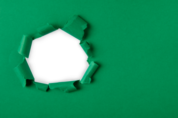 green and white Hole in the paper with torn sides.