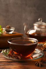 Aromatic tea with anise stars and mint on wooden table