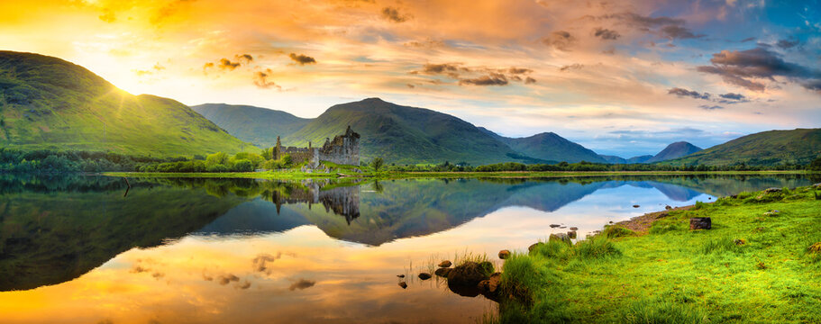 The ruins of Kilchurn castle at sunset on Loch Awe, the longest fresh water loch in Scotland - Powered by Adobe