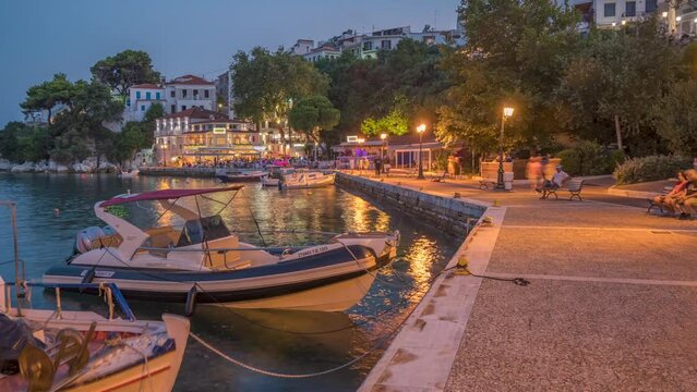 Time lapse of boats and restaurant in the Old Port at dusk, Skiathos Town, Skiathos Island, Sporades Islands, Greek Islands