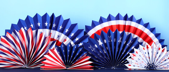 Blue red and white paper fans on blue background. American flag colors holiday decorations. Banner for Presidents Day, 4th of July, Memorial day, Veteran's day celebration.