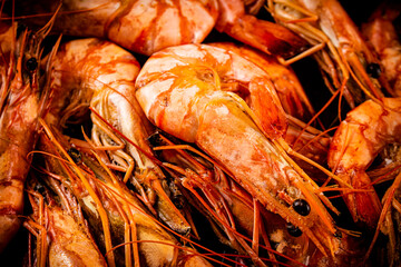 Red shrimp are boiled in water. Macro background. 