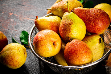 Ripe pears in a colander. 