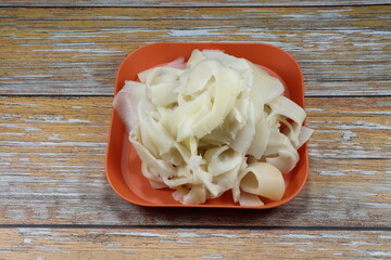 Pile of fresh and organic young bamboo shoot serving in the plate. Famous ingredient in Thai restaurant. 