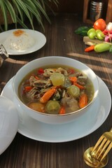 Spicy and sour beef rib soup in a white bowl