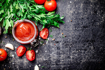 Tomato sauce in a glass jar with parsley and garlic. 