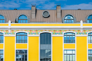 facade decorated with tiles, painted yellow