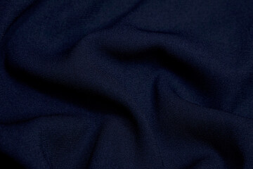 Black fabric background. Black cloth waves Background texture. Black fabric cloth textile material.