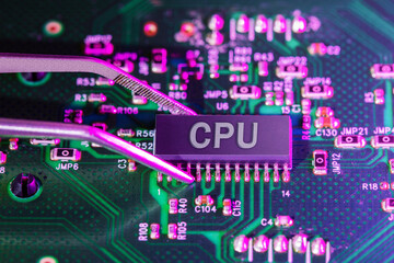 Electronic technician holding tweezers with CPU chip.   Technology background. Conept of repair pc.