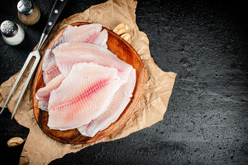 Fresh fish fillet on a wooden plate. 