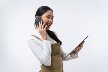 Happy young Asian woman using tablet and speaking on smartphone isolated on white background.