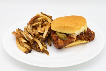 Simple Fried Chicken Sandwich with a Side of French Fries on a White Plate