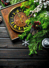 Retro clock with Christmas tree branches and decorations.