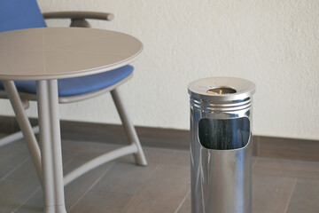 Close up burning cigarette in ashtray on table 