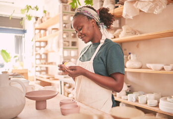 Pottery, craft and black woman creating with clay for her small business in creative workshop. Creativity, handicraft and African female potter entrepreneur manufacturing product with mud for a store