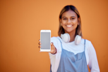 Naklejka premium Portrait, mockup and woman with smartphone, smile and screen with girl on brown studio background. Face, female and girl with cellphone, space or connection for social media, chatting and on backdrop