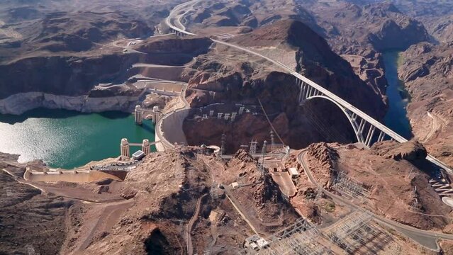 Aerial of the Bridge by the Hoover The Hoover Dam, a Major tourist attraction in the USA. The dam on the Colorado river impounds Lake Mead, Four-lane Hoover Dam Bypass it includes steel and concrete.