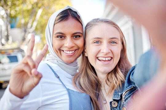 Selfie, peace sign and couple of friends with social media post, profile picture and gen z portrait in city park. Photography, smile and happy diversity or muslim teenager with hand sign on internet