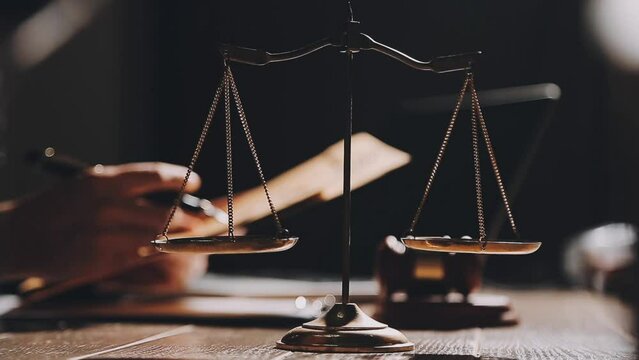 Business and lawyers discussing contract papers with brass scale on desk in office. Law, legal services, advice, justice and law concept picture with film grain effect
