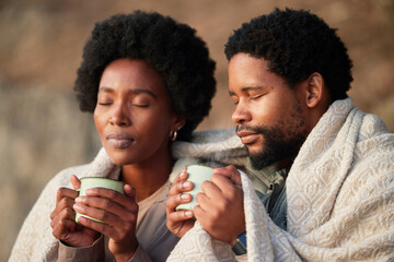 Relax, peace and camping with black couple and coffee for wake up, hiking and sunrise. Nature, calm and adventure with man and woman and blanket in nature for trekking, mountaineering and discovery