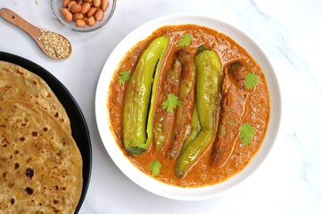Mirchi or mirch ka Salan. Green chilly sabzi. It is a popular Indian chili and peanut curry from Hyderabad. Accompanies Hyderabadi mutton or chicken biryani. Copy space. - obrazy, fototapety, plakaty