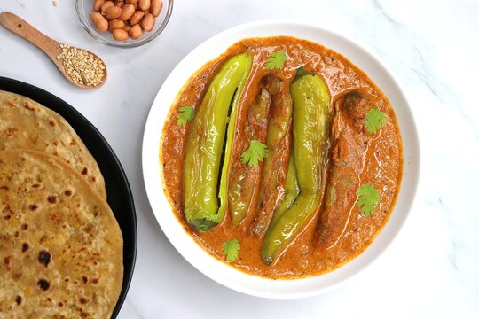 Mirchi or mirch ka Salan. Green chilly sabzi. It is a popular Indian chili and peanut curry from Hyderabad. Accompanies Hyderabadi mutton or chicken biryani. Copy space.