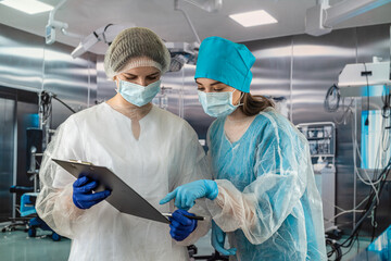 Two female doctors are talking in the clinic of surgery and dentistry.