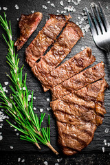 Grilled steak with a sprig of rosemary. 