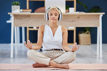 Music, meditation and yoga with a business black woman finding inner peace or zen in her office. Headphones, mental health and balance with a calm female eployee meditating at work for wellness
