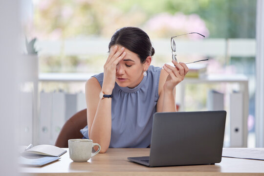 Stress, Headache And Business Woman In The Office Doing Research Or Planning A Corporate Strategy. Migraine, Exhausted And Tired Professional Female Working On A Project With A Deadline On A Laptop.