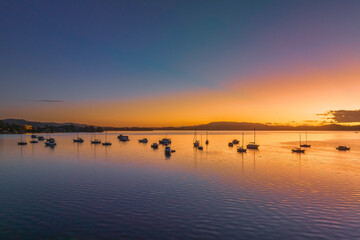Aerial sunrise waterscape over the bay with boats