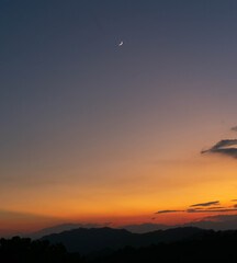 Fototapeta na wymiar The evening, the last light and the moon on the mountain