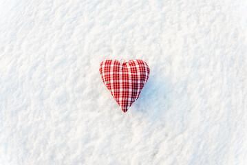 A red heart flat lay on the snow top view, valentines day concept.White snow background.Copy space.