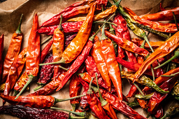 Dried chili peppers on paper. 
