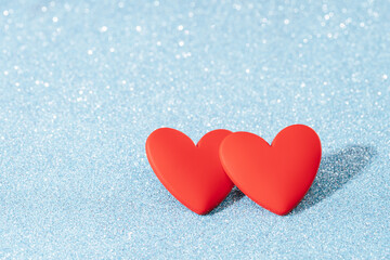 Two Red hearts, love greeting card. Bokeh blue abstract sparkling background. Valentines Day card or winter wedding