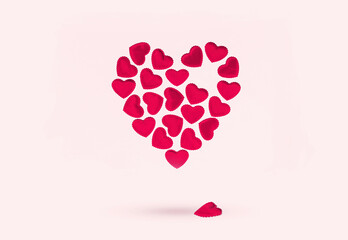 St Valentines day or thank you concept. Many magenta red hearts form bigger heart shape floating on...