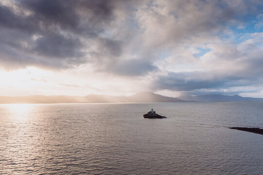 Aerial panorama view of the historic Fenit Lighthouse in Tralee Bay, beautiful clouds, sunset. High quality photo