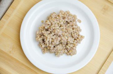 boiled green buckwheat in a plate. healthy food concept